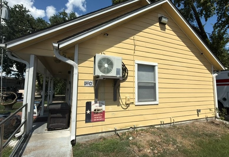 Jus Passn Thru RV Park office building with welcome sign