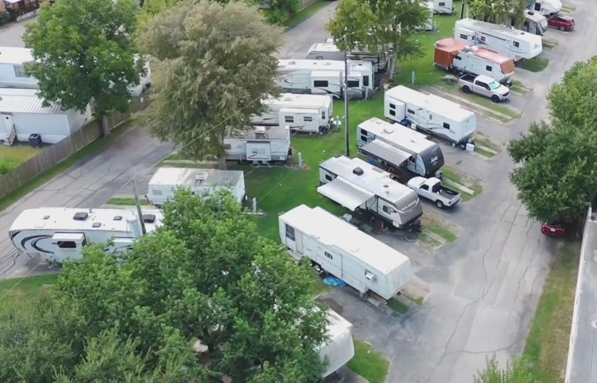 Aerial view of paved road running through RV park with sites on both sides